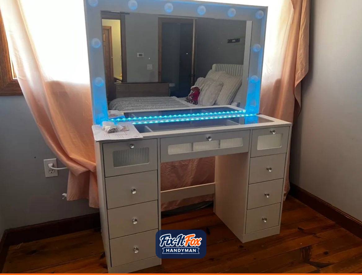 Assembled white makeup vanity with drawers, glass top, bulb-lit mirror and blue LED lights